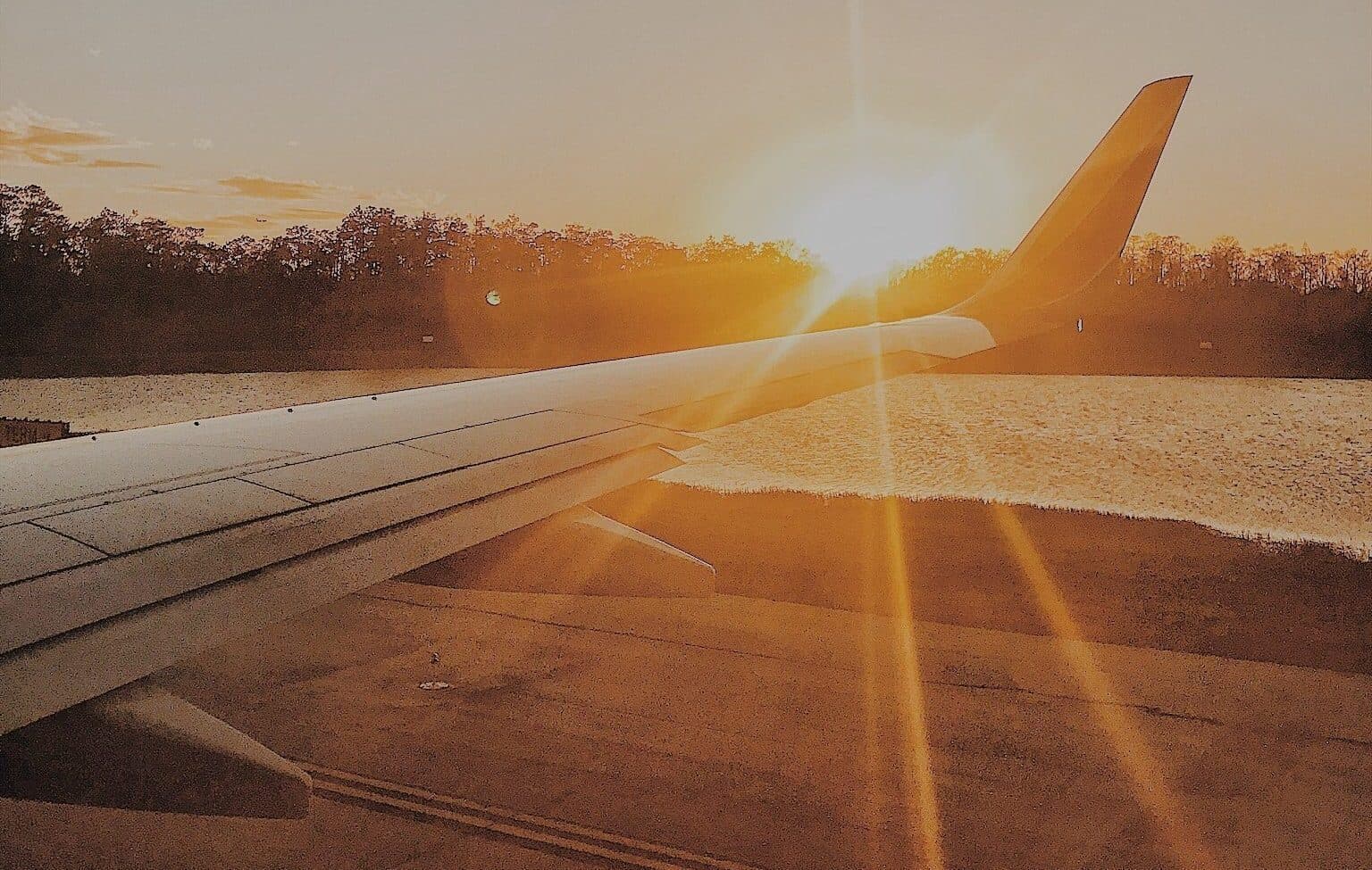 Airplane Wing with Sunset e1625166411373